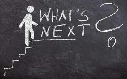 Blackboard illustration, with stick figure climbing steps; text of "What's Next?"